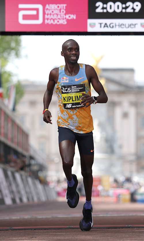 Jacob Kiplimo crosses the line at the TCS London Marathon 2026, with his time of 2h 00m 29s displayed behind him - what would have been a world record at every previous marathon in history.