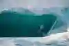Surfer Reef McIntosh pulls into a big tube at Backdoor on the North Shore in Oahu, Hawaii