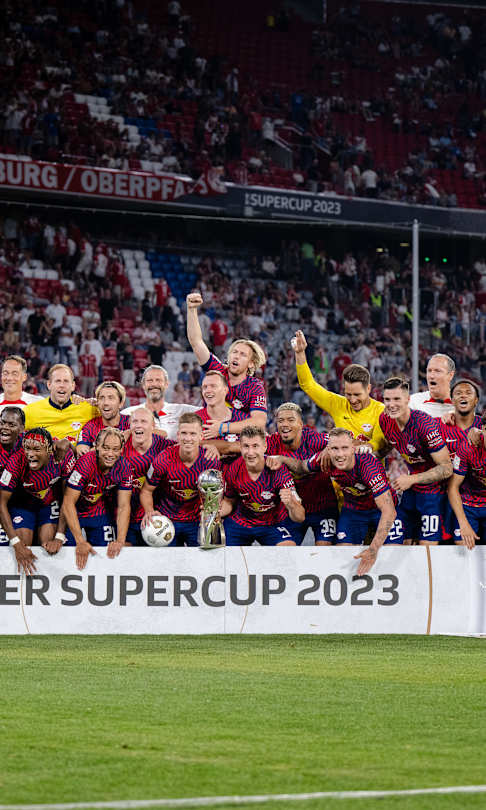 RB Leipzig players and staff celebrate beating Bayern Munich in the 2023 German Supercup.