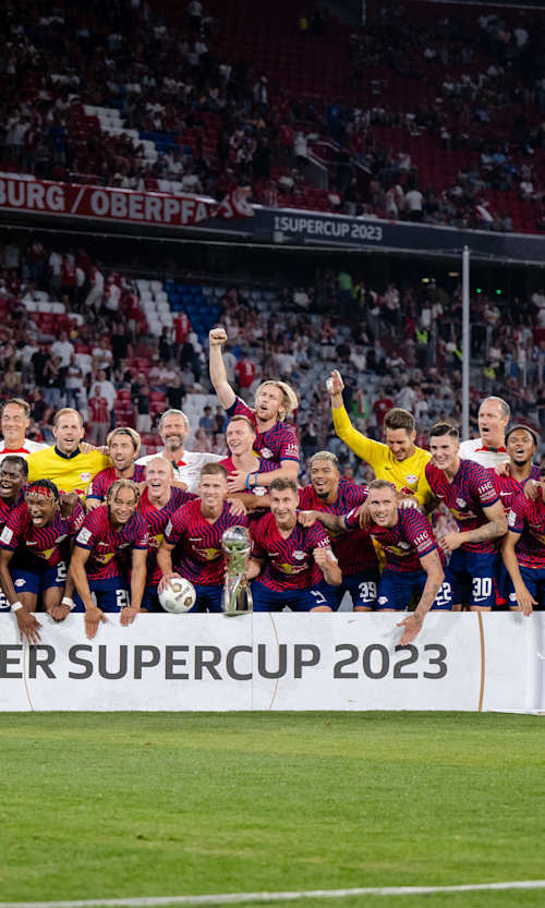 RB Leipzig players and staff celebrate beating Bayern Munich in the 2023 German Supercup.
