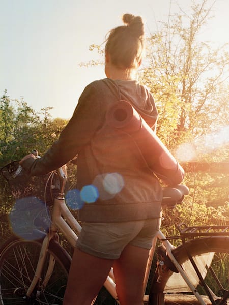 A cyclist with a yoga mat
