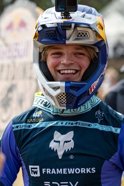 In 2025, Asa Vermette is ready for action at Red Bull Hardline, Maydena Bike Park, Tasmania, sporting a GoPro and signature Red Bull helmet among world-class riders.