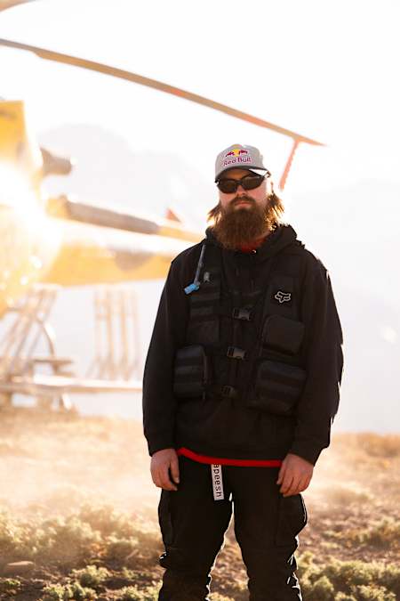 Brage Vestavik stands in front of a helicopter during the production of ANYTIME in Chile on January 19, 2024.