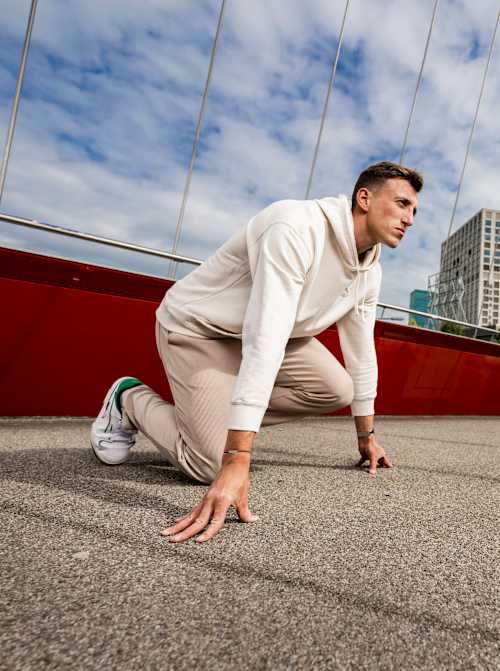 Swiss decathlete Simon Ehammer assumes a race-start position during a photoshoot for the Red Bulletin.