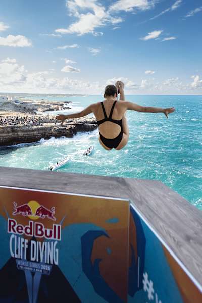 Simone Leathead of Canada launches from the 20-metre balcony in Polignano a Mare, Italy, during the first round of the Red Bull Cliff Diving World Series 2026 final stop