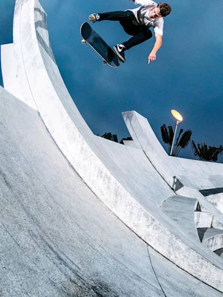 Skater Yoshi Tanenbaum boosts a Backside Kickflip on a monument in Hong Kong