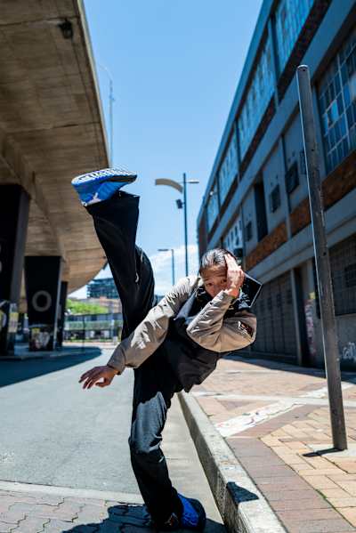 Dancer THE D Soraki poses performing a high kick in Japan.