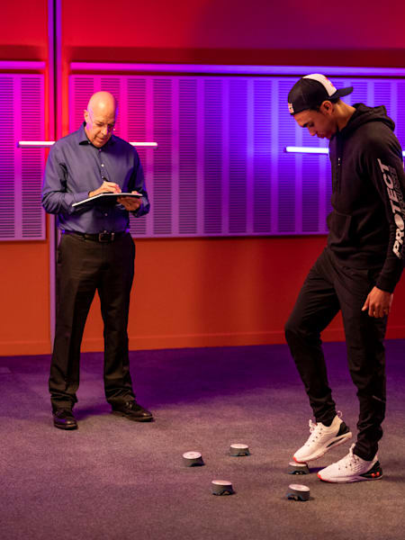Dr. Daniel Laby watches Trent Alexander-Arnold practise his foot-eye co-ordination.