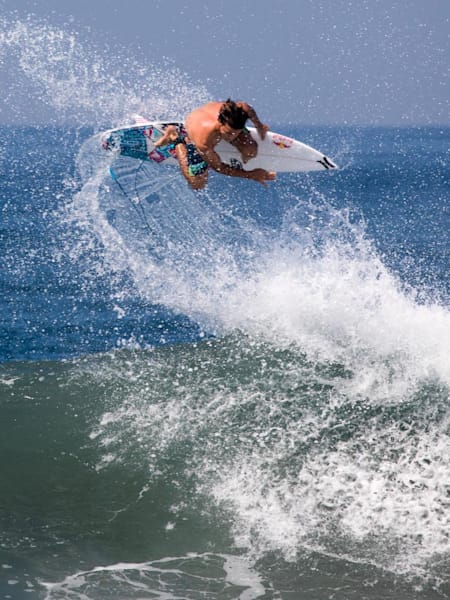 Julian Wilson performs an aerial while surfing in Bali, Indonesia.