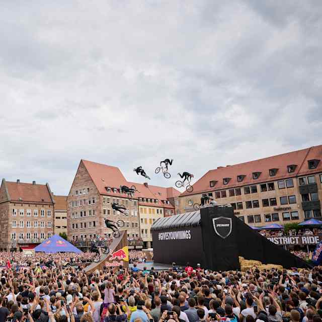 An MTB rider performs in front of spectators at Red Bull District Ride 2022 in Nuremberg, Germany