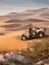 Drivers survey the sand dunes from their car at the Dakar Rally.