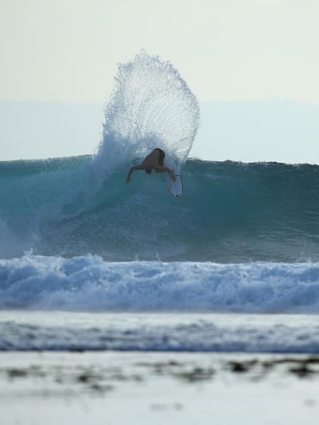 Leo Fioravanti performs a backhand turn while surfing at Desert Point in Indonesia.