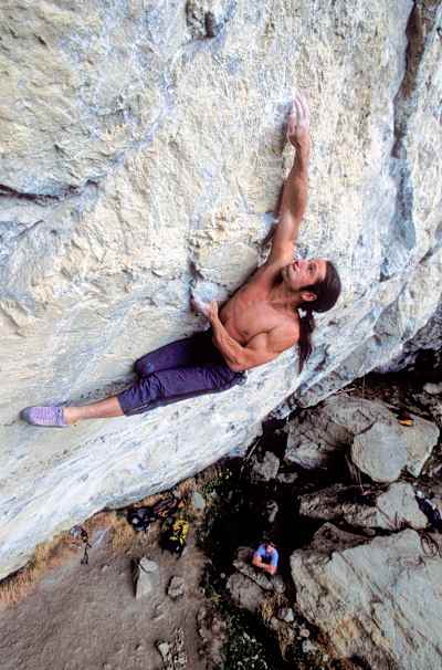 Climber Alexander Huber free solo climbs Kommunist in Tyrol, Austria in 2004.