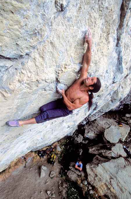 Climber Alexander Huber free solo climbs Kommunist in Tyrol, Austria in 2004.