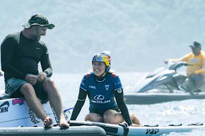 Jake Paterson and Erin Brooks talk strategy between heats at the Tahiti Pro