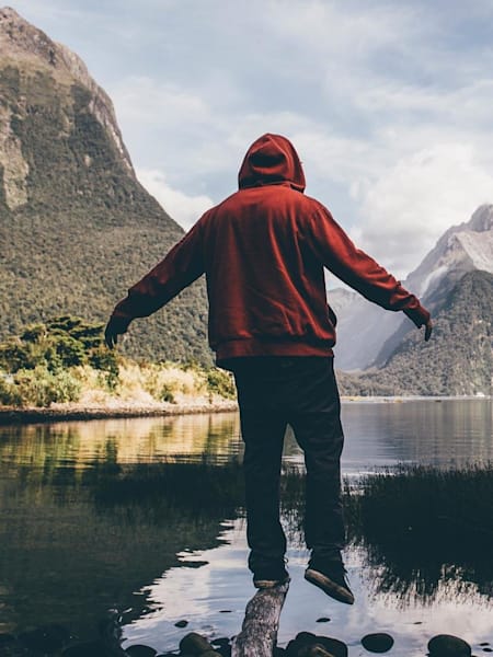 Dustin Orem takes in views from the lakeside at Milford Sound.