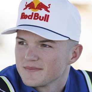 Supercross rider Chance Hymas poses for a portrait photo wearing a white Red Bull cap.