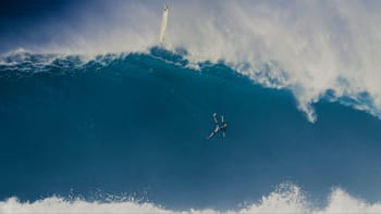 Surfer Tom Dosland flies through the air on a huge wave at Jaws