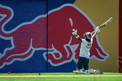 In April 2025, KL Rahul exults after a powerful shot during the Red Bull Cricket Challenges in Mumbai, India, embodying Red Bull's energetic spirit on the pitch