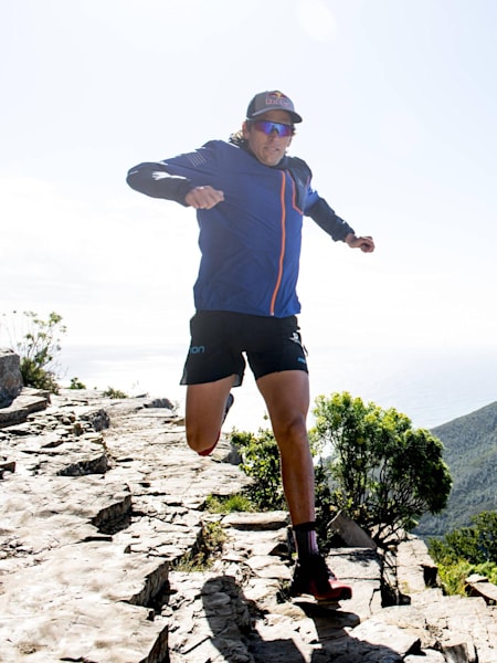 Ryan Sandes runs over a rocky outcrop in Drakensberg, South Africa.