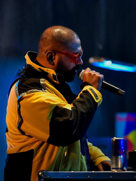 Rapper D'Evil performs with the mic and on the console at Red Bull Spotlight.