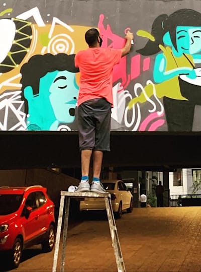 Abhedya Bhagawan works on a graffiti artwork