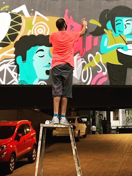 Abhedya Bhagawan works on a graffiti artwork