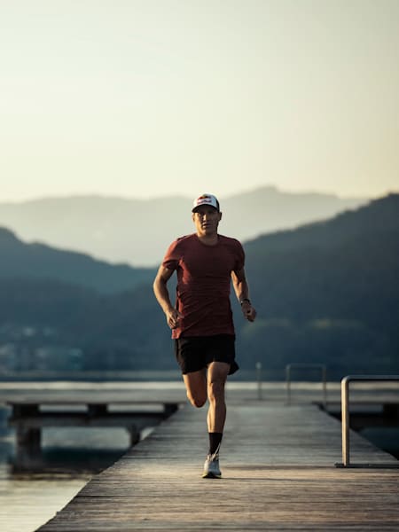 Braden Currie runs along a plank walk in New Zealand.