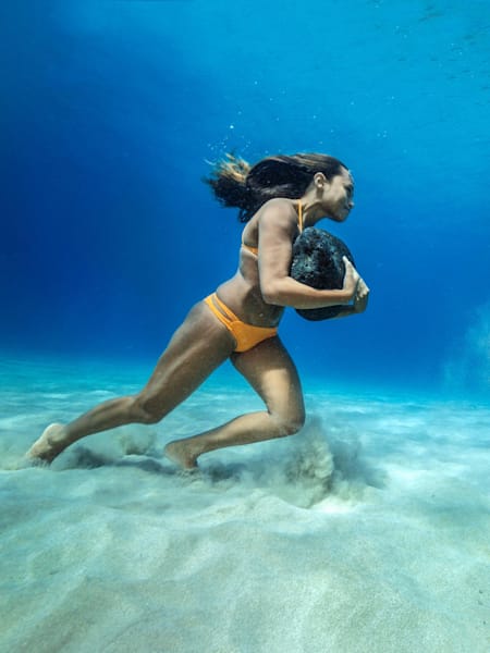 Ha'a Keaulana, 26, performs her boulder workout at a depth of 30 feet in the Pacific Ocean.