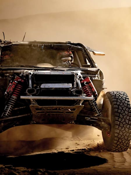 Carlos Sainz roule vers le bivouac au volant de sa voiture accidentée lors du rallye-raid Dakar 2025. 