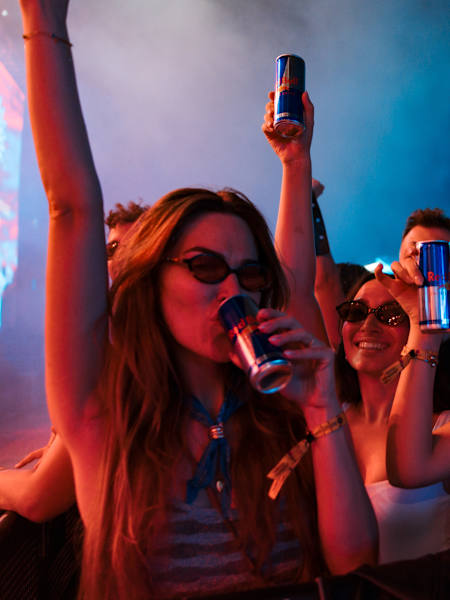 Festivalgoers celebrate with cans of Red Bull at the Sunny Hill Festival in Pristina, Kosovo, in August 2025.