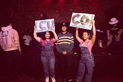 Cuco poses with a couple of festive supporters after the Hi Hat set.