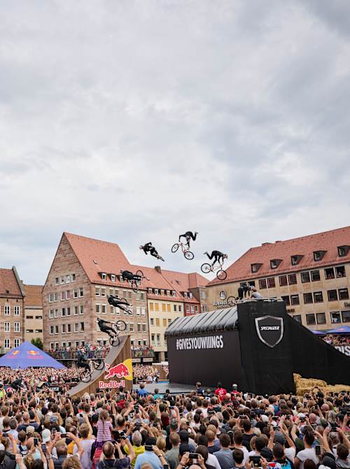 An MTB rider performs in front of spectators at Red Bull District Ride 2022 in Nuremberg, Germany