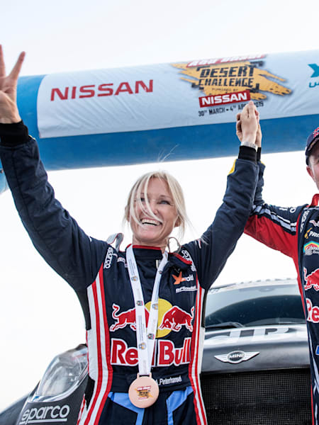 A photo of Stéphane Peterhansel and Andrea Peterhansel celebrating winning the 2019 Abu Dhabi Desert Challenge.