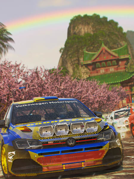 Screenshot of vehicles racing under a rainbow in DiRT 5