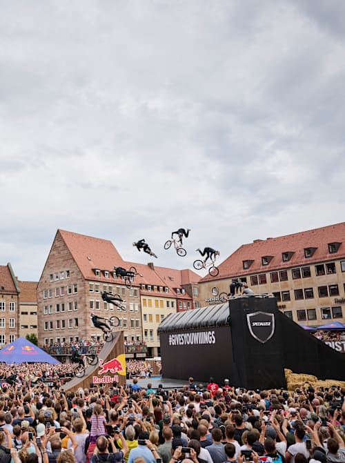 An MTB rider performs in front of spectators at Red Bull District Ride 2022 in Nuremberg, Germany