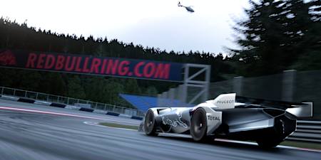 A Peugeot L750R Hybrid Vision Gran Turismo takes a long corner on the Red Bull Ring in the game Gran Turismo 7.