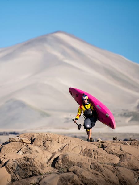 Dane Jackson walks with his kayak after dropping the Salto Del Maule 134-foot waterfall, the second greatest kayak descent, on the Salte Maule river in Chile on 5 February, 2020.