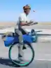 Ed Pratt rides his unicycle and juggles apples