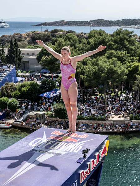 Molly Carlson prepares to dive from the 21-metre platform for the first stop of the 2024 Red Bull Cliff Diving World Series at Lake Vouliagmeni in Athens, Greece, on May 25, 2024.