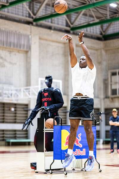 Lethal Shooter and Cue6 shooting hoops on a basketball court in Tokyo, Japan.