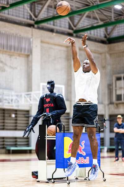 Lethal Shooter and Cue6 shooting hoops on a basketball court in Tokyo, Japan.