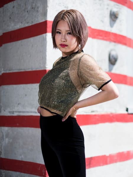 Ibuki poses in front of a white wall with red stripes