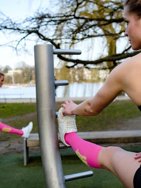 Women stretch while wearing CEP compression socks.