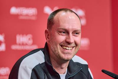 Ole Werner beaming at a press conference.