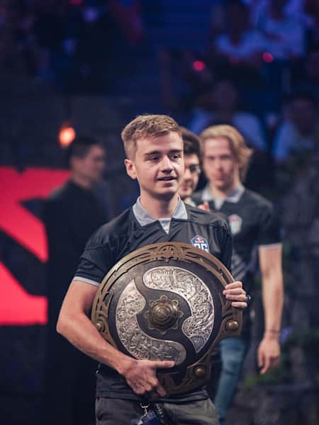 OG player N0tail carries the The International trophy at TI9 in Shanghai, China.