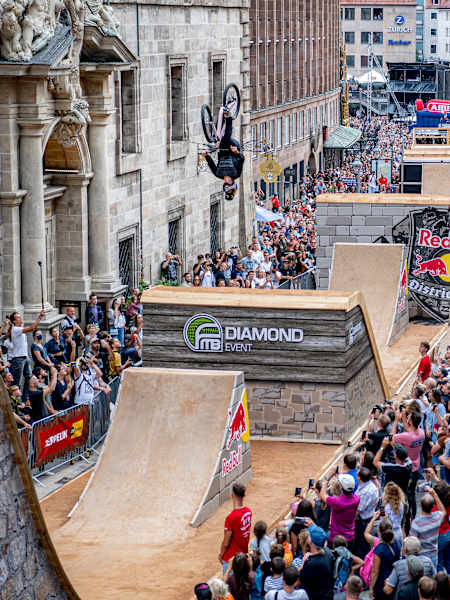 Swedish rider Emil Johansson wows the packed crowd lining the streets with a gravity-defying trick at Red Bull District Ride 2022 in Nuremberg, Germany.
