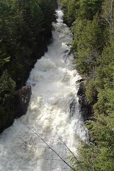 Les Chutes-de-Sainte-Ursule waterfall and rapids seen in springtime.