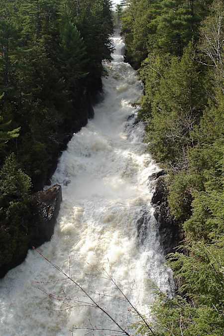 Les Chutes-de-Sainte-Ursule waterfall and rapids seen in springtime.