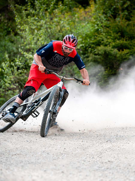 Rob Warner drifting a dusty turn on his mountain bike.